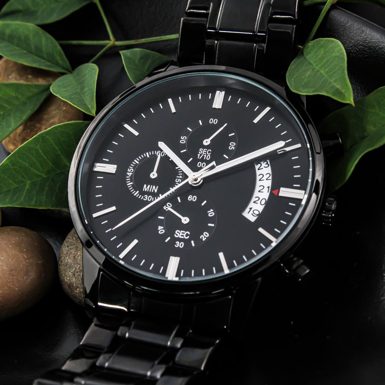 Blackout Watch laying on leaves & rocks